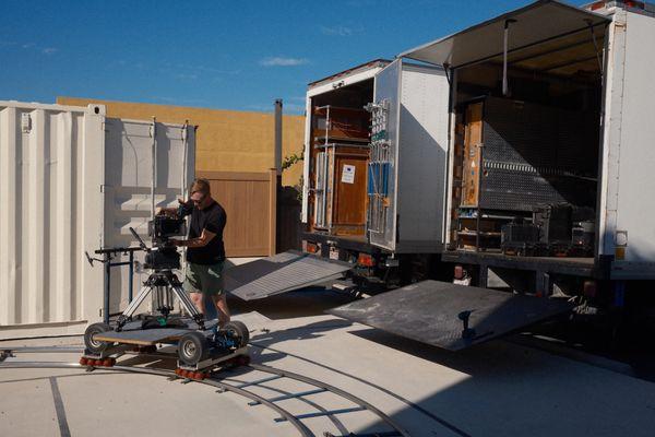 Owner Trevor Elliott operating the Venice 2 on our Matthews Doorway Dolly next to our 3-ton Grip Trucks