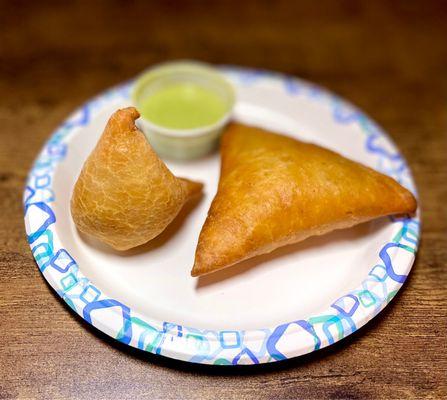 Chicken samosa on right and desi shingara on left with green sauce