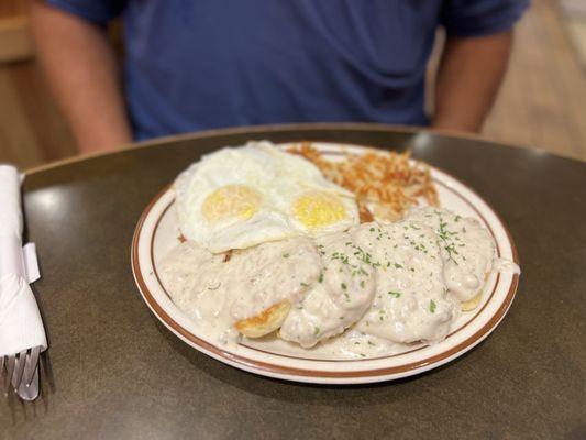 Biscuits and gravy with eggs and hash browns
