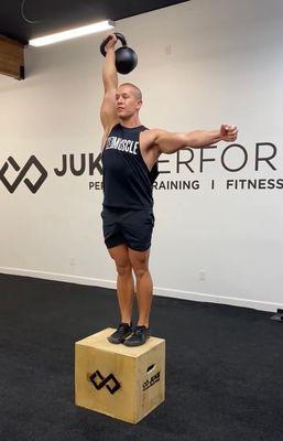 Cam demonstrating a kettlebell exercise for me