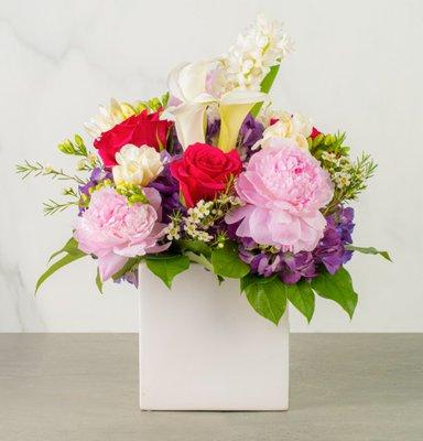 Amelia - Designed with peonies, calla lillies, hyacinth and hydrangea in a 6" white ceramic cube.