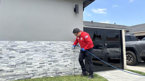 Here we have one of our highly trained technicians performing a Subterranean Termite Treatment.