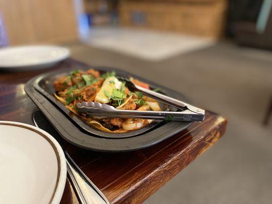 Chicken tikka. Sizzling platter with spiced chicken and caramelized onions.