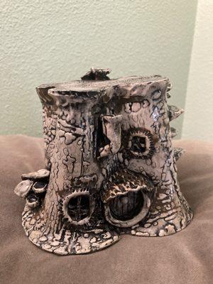 Pictured is a clay sculpture I made at Cascade Ceramics of a black and white "gnome house".