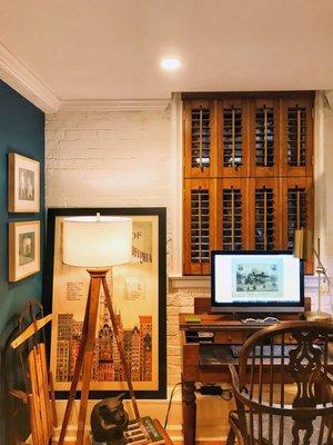 Café style shutters to accommodate AC during the summer.