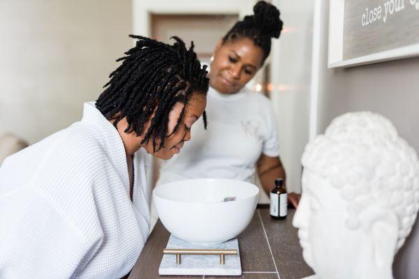 OMG founder, Shayla supports a client during an aromatherapy session utilizing a custom blend of essential oils.