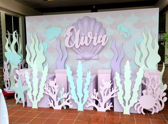 Under the Sea themed props, display columns, and backdrop wall