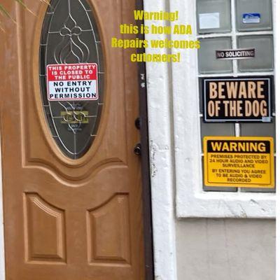 Signs on door discouraging customers but no business sign!