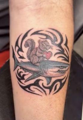 A custom design tattoo I did for a shark biologist with a squirrel writing on the back holding a heart representing a loved one
