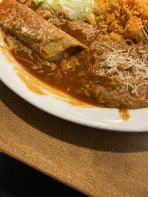 Inedible enchilada and orange rice and beans