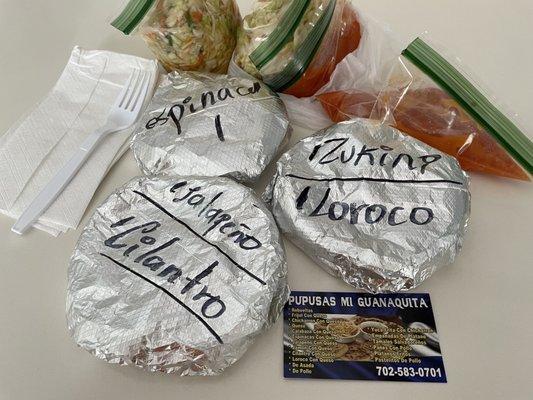 Five different pupusas with cabbage and red sauce