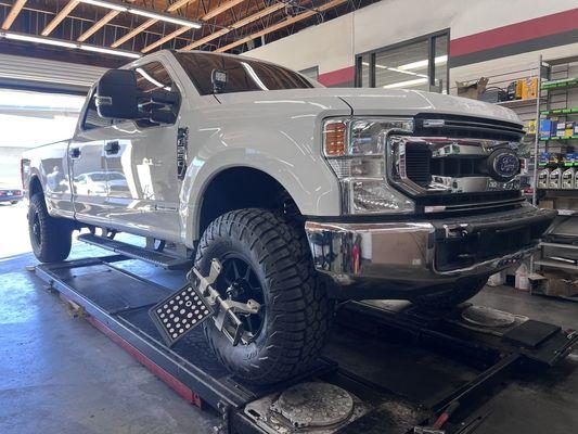 Ford F-250 getting a wheel alignment.
