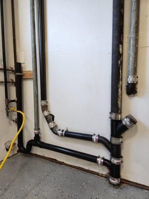 New black PVC piping Peter and his crew installed. They also put a block on top left above P Trap to help stabilize for laundry and washer.