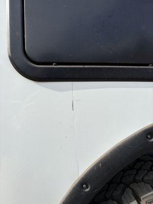 Body work failed and crack emerged shortly after repair Notice how they never bothered to caulk the wheel well.