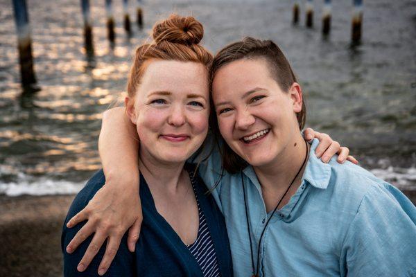 Midwives Elliott (left) and Lizz (right) smile at the beach. Photo by Instinctive Birth & Beyond.