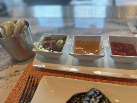 Complimentary guacamole, queso and salsa with the chips