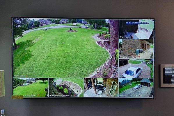 75" TV mounted with hardwired Security canera services.