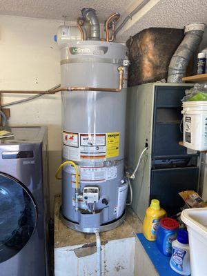 New hot water heater with additional expansion tank also installed along with a PVC downspout