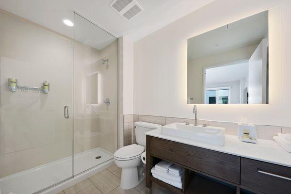 Feel refreshed in our spa-like guest bathrooms featuring a rain shower and the convenience of product dispensers for an eco-friendly space.