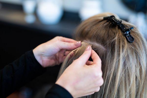 Stylist applying extensions.