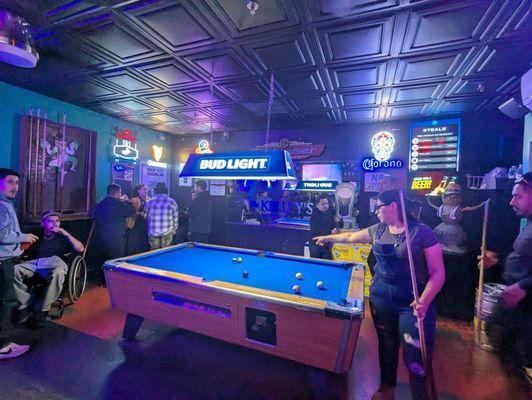 It's time to play a game of pool in the room behind the bar area