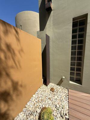 The space by the orangish wall leads out to the walkway that leads to the rooms 221 and 222.