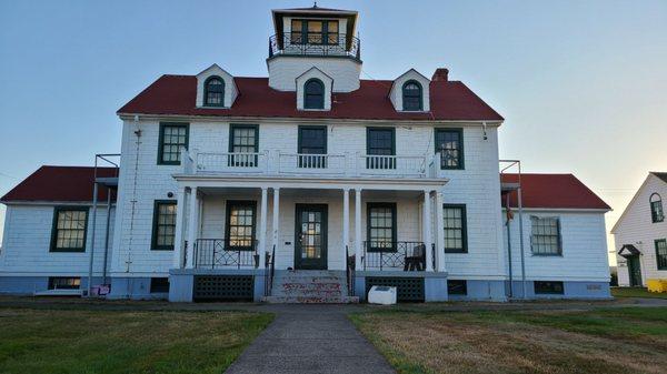 Westport Maritime Museum back-lit by the setting sun.