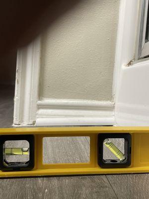 Just outside shower, floor is not level, dangerous, hard to balance & determine slant perception.