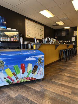 Counter service with muffins and cinnamon rolls ready to go and freshly made breakfast sandwiches, juices, and smoothies.