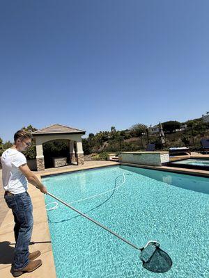 Ethan netting the top of the pool.