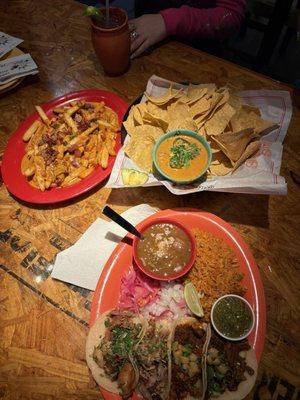 Smothered fries, nachos, and 4 tacos con arroz y frijoles charros