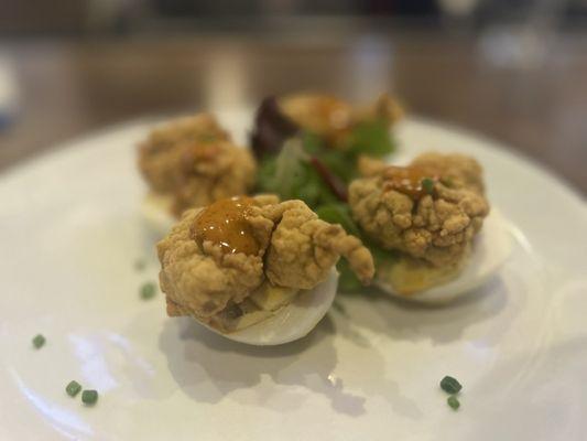 Deviled eggs with fried oysters and smoky chipotle mayo.
