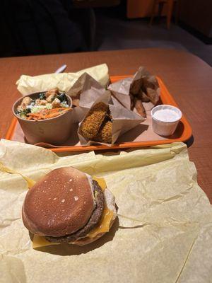 Burrito (wrapped), potato wedges, baked tofu, salad, and pier burger