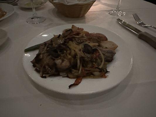 Pork chop with mushrooms, onions and cherry peppers.