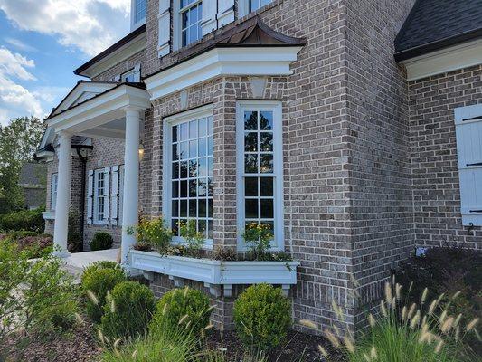 Tinted windows on front of house for privacy and heat reduction.
