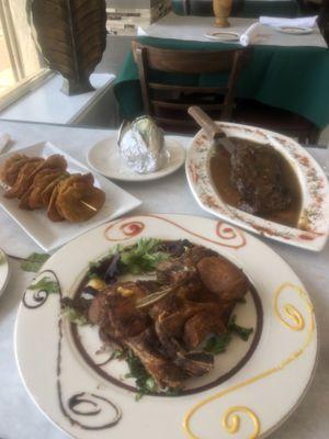 Fried pork chops, Tostones and skirt steak with baked potato