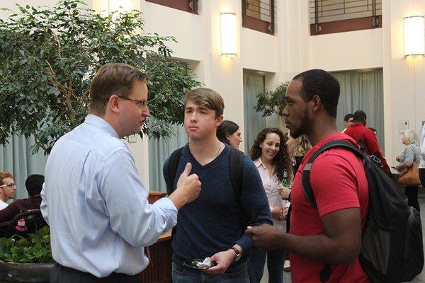 Brian Stolarz '99 speaking with students after a presentation at the law school.