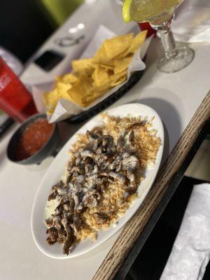 Steak, queso, rice and chips