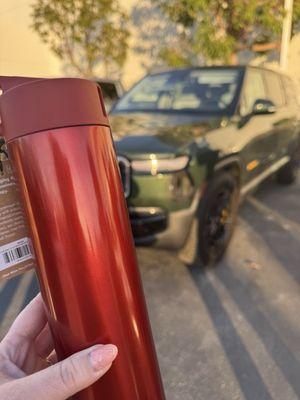 Red Canyon Water Bottle in front of a Forest Green R1S. (I wasn't sure on color)