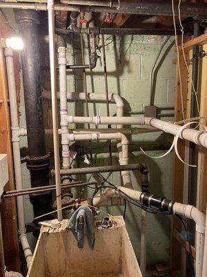 The new pvc pipe is attached to an old galvanized pipe, which Alex cut. It's in the back behind all the other pvc pipe and against the wall.