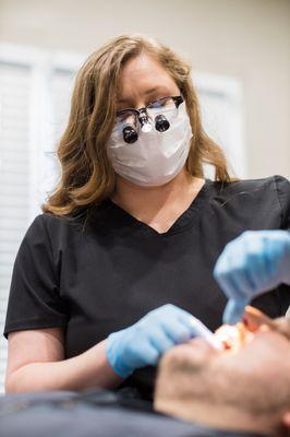 Our hygienist showing patients how to floss correctly.