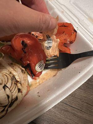 Produce stickers still stuck onto cooked vegetables.