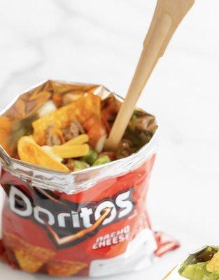 Walking Taco served with taco meat, cheese, lettuce, sour cream, salsa so delicious