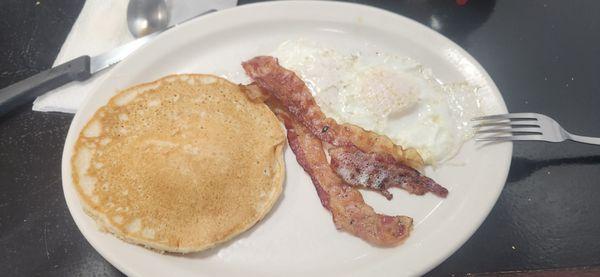 The breakfast plate. 1 pancake 2 eggs 2 bacon. Price is right.