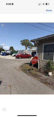 Improper placement of stop sign , causes garbage trucks to hit it and fed ex trucks, UPS etc.. on tenants lot