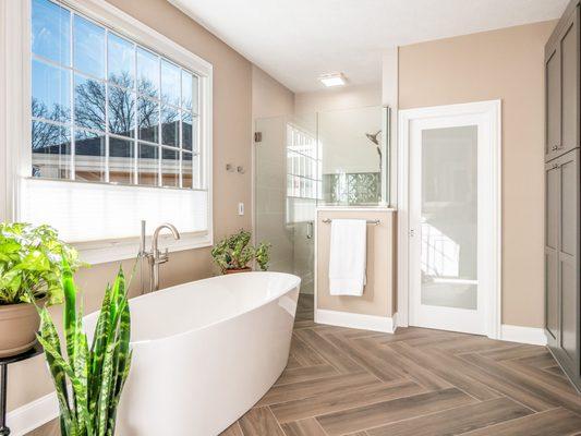 Featuring a soaking tub and waterfall edge shower wall