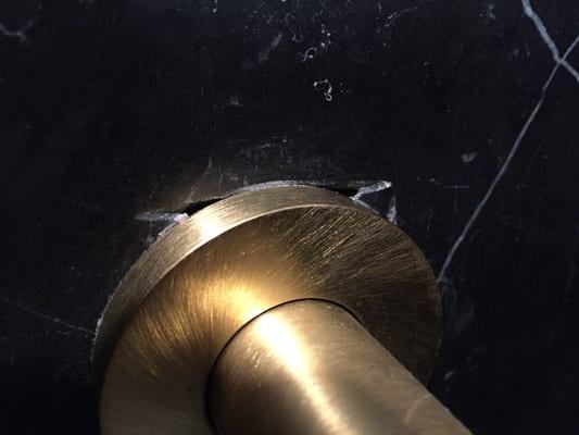 Open Holes cut in tile around shower fixture.