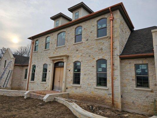 A beautiful home with real copper gutters customized by Aqua works rain gutters