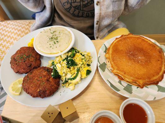 Salmon croquettes, grits, eggs with spinach, and pancakes.