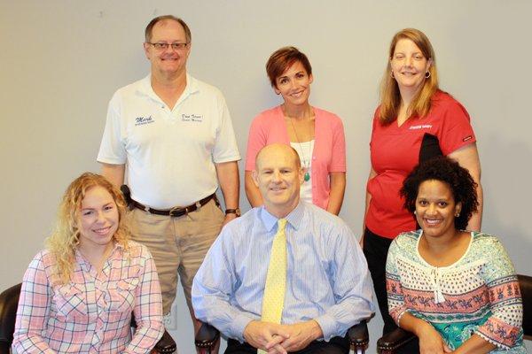 Dr. Lee Bazzarone with his team at the Vienna Oaks Chiropractic Center. Including two massage therapists